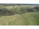Aerial view of a lot with scattered trees and a small pond at 10624 N 200 W, Alexandria, IN 46001