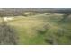 Expansive aerial shot of a large, grass-covered lot with tall bare trees at 10624 N 200 W, Alexandria, IN 46001