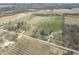 An aerial view showcases several houses, open land and tree lines at 10624 N 200 W, Alexandria, IN 46001