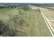 Aerial view features expansive open land and wooded areas along roadways at 10624 N 200 W, Alexandria, IN 46001