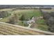 An aerial shot displays several structures, open land, and a roadway at 10624 N 200 W, Alexandria, IN 46001