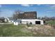 Rustic barn with white siding and weathered roofing with farm equipment nearby at 10624 N 200 W, Alexandria, IN 46001