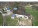 Aerial view of a rustic barn featuring weathered wood, vintage roofing, and some farm equipment at 10624 N 200 W, Alexandria, IN 46001