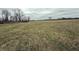 Expansive field presents an opportunity for development or recreation under a cloudy sky at 10624 N 200 W, Alexandria, IN 46001
