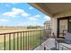 Enjoy outdoor living on this balcony with comfortable chairs overlooking the lush golf course at 10744 Eldorado Cir, Noblesville, IN 46060