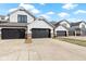 Charming townhouses with gray garages, stone accents, and white siding offer curb appeal at 10744 Eldorado Cir, Noblesville, IN 46060