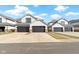 Charming townhouses with gray garages, stone accents, and white siding offer curb appeal at 10744 Eldorado Cir, Noblesville, IN 46060