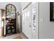 Bright foyer showcasing a decorative cabinet and beautiful front door at 10744 Eldorado Cir, Noblesville, IN 46060