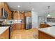 The kitchen features stainless steel appliances, hardwood floors, and plenty of cabinets for storage at 10744 Eldorado Cir, Noblesville, IN 46060