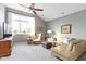 Bright living room with vaulted ceiling, large windows, comfortable seating, and a ceiling fan at 10744 Eldorado Cir, Noblesville, IN 46060