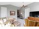 Spacious living room with neutral walls, leather sofa set, ceiling fan, and a decorative painting on the wall at 10744 Eldorado Cir, Noblesville, IN 46060