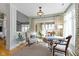 Bright living room featuring a decorative chandelier, neutral furnishings, and a view to an outdoor seating area at 10744 Eldorado Cir, Noblesville, IN 46060