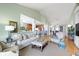 The living room opens up to the kitchen and has hardwood floors, neutral paint, and cozy furniture at 10744 Eldorado Cir, Noblesville, IN 46060