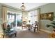 Cozy sunroom with large windows, decorative chandelier, neutral furnishings, and natural light at 10744 Eldorado Cir, Noblesville, IN 46060