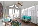 Inviting sunroom with vaulted ceiling, ceiling fan, ample seating, and views of the backyard at 10744 Eldorado Cir, Noblesville, IN 46060