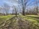 Expansive backyard with mature trees and a storage shed at 110 Pleasant Run Dr, Markleville, IN 46056
