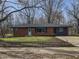 Charming single story home with a brick facade, blue door, and large front yard at 110 Pleasant Run Dr, Markleville, IN 46056