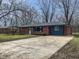 Well-maintained home with a brick facade, mature trees, and a concrete driveway at 110 Pleasant Run Dr, Markleville, IN 46056