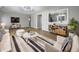 Bright living room featuring hardwood floors, light walls, and a decorative rug at 110 Pleasant Run Dr, Markleville, IN 46056