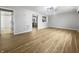 Open living room with new hardwood floors, modern light fixture, and neutral paint at 110 Pleasant Run Dr, Markleville, IN 46056