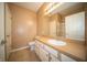 Bright bathroom featuring white cabinets, tan countertop, and a large mirror at 123 Bridgemor Ln, Mooresville, IN 46158