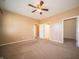 Bedroom with ceiling fan, two doorways, and large window for natural light at 123 Bridgemor Ln, Mooresville, IN 46158