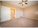 Bright bedroom featuring a ceiling fan, neutral carpet, and two doorways at 123 Bridgemor Ln, Mooresville, IN 46158