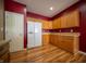 Functional kitchen featuring wooden cabinets, a white refrigerator, and durable wood-look flooring at 123 Bridgemor Ln, Mooresville, IN 46158