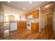 Traditional kitchen with wood cabinets, white appliances, and modern wood flooring at 123 Bridgemor Ln, Mooresville, IN 46158
