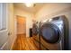Bright laundry room featuring new washer and dryer units and built in shelving at 123 Bridgemor Ln, Mooresville, IN 46158