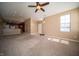 Open-concept living room with vaulted ceilings, connecting to the kitchen, featuring neutral paint and carpeting at 123 Bridgemor Ln, Mooresville, IN 46158