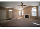 Inviting living room featuring vaulted ceilings, fireplace, and ample natural light through large, arched windows at 123 Bridgemor Ln, Mooresville, IN 46158