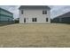 The backyard features a new lawn, a door for access to the home, and a view of neighboring houses at 1265 Fleming Dr, Greenfield, IN 46140