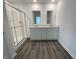 Well-lit bathroom featuring double sinks, modern fixtures, and a glass enclosed walk-in shower at 1265 Fleming Dr, Greenfield, IN 46140
