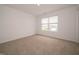 Bright bedroom featuring neutral carpeting, a large window, and fresh, neutral paint at 1265 Fleming Dr, Greenfield, IN 46140