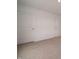 Spacious bedroom showing fresh, neutral paint and carpeting with multiple doors at 1265 Fleming Dr, Greenfield, IN 46140