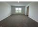 Empty bedroom features neutral carpeting and a large window offering a pleasant outdoor view at 1265 Fleming Dr, Greenfield, IN 46140