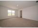 Well-lit bedroom featuring neutral carpet, a large window and a door leading to other rooms at 1265 Fleming Dr, Greenfield, IN 46140