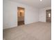 Bedroom with neutral carpet, offering a glimpse into the en-suite bathroom and connecting rooms at 1265 Fleming Dr, Greenfield, IN 46140