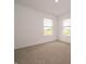 Bright bedroom with neutral carpeting and paint, featuring dual windows for lots of light at 1265 Fleming Dr, Greenfield, IN 46140