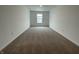 Empty room with neutral carpeting and a large window offering plenty of natural light at 1265 Fleming Dr, Greenfield, IN 46140