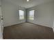 Bright bedroom featuring neutral carpet, two windows and neutral walls at 1265 Fleming Dr, Greenfield, IN 46140