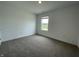 Cozy bedroom features neutral carpeting and is illuminated by natural light filtering through a large window at 1265 Fleming Dr, Greenfield, IN 46140