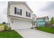 Charming two-story home showcases a two-car garage and a spacious driveway at 1265 Fleming Dr, Greenfield, IN 46140