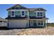 New two-story home features an attached two-car garage and covered entryway, still under construction at 1265 Fleming Dr, Greenfield, IN 46140