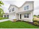 Two-story home with a well-manicured lawn, a two-car garage, and a cozy front porch at 1265 Fleming Dr, Greenfield, IN 46140