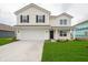 Charming two-story home features a two-car garage, black shutters, and a well-manicured lawn at 1265 Fleming Dr, Greenfield, IN 46140