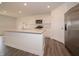 Modern kitchen features stainless appliances, white cabinets, and gray wood flooring at 1265 Fleming Dr, Greenfield, IN 46140