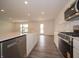 Bright kitchen featuring stainless appliances, quartz countertop, and gray wood floors at 1265 Fleming Dr, Greenfield, IN 46140