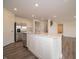 Modern kitchen with island, stainless appliances, white cabinets, and gray wood flooring at 1265 Fleming Dr, Greenfield, IN 46140